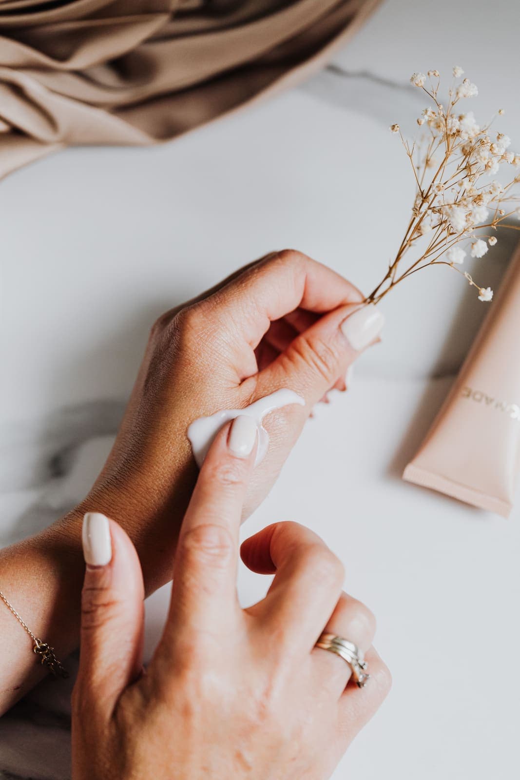 Hands applying a rich moisturizing cream, the kind of hydration dry skin needs.
