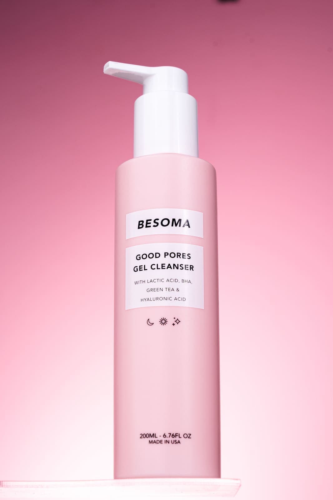 A pink-toned gel cleanser bottle, the kind of lightweight formula recommended for oily skin.